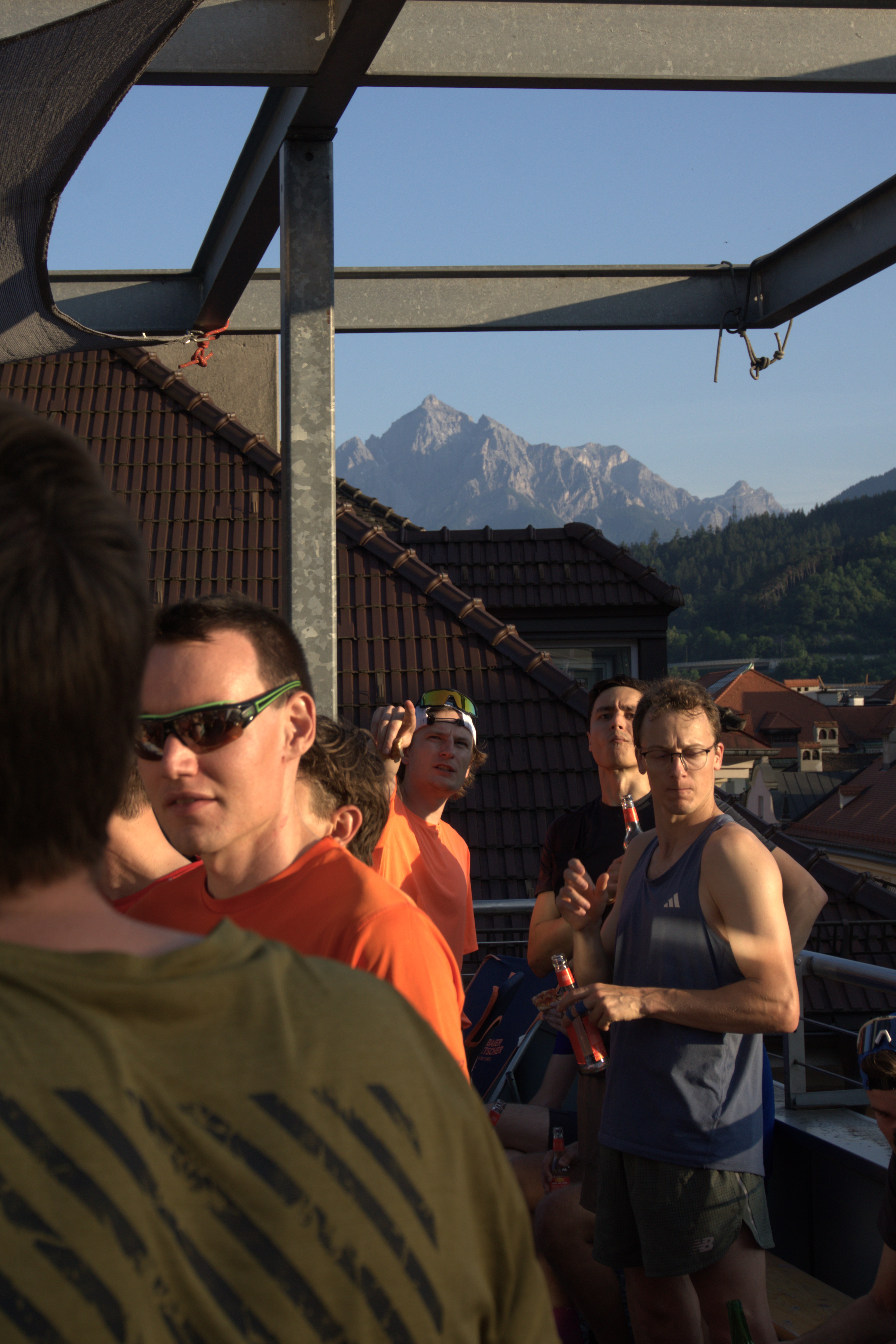 Runners having a drink on a rooftop after a run