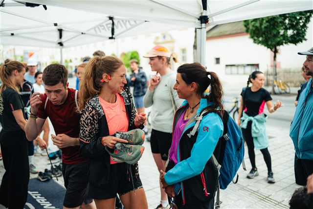 Community runners chatting and trying trail shoes at a Dynafit event
