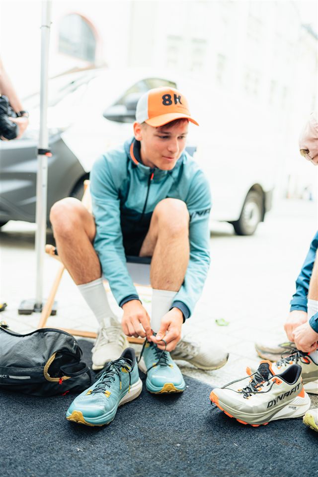 A runner trying on trail shoes at a Dynafit community event