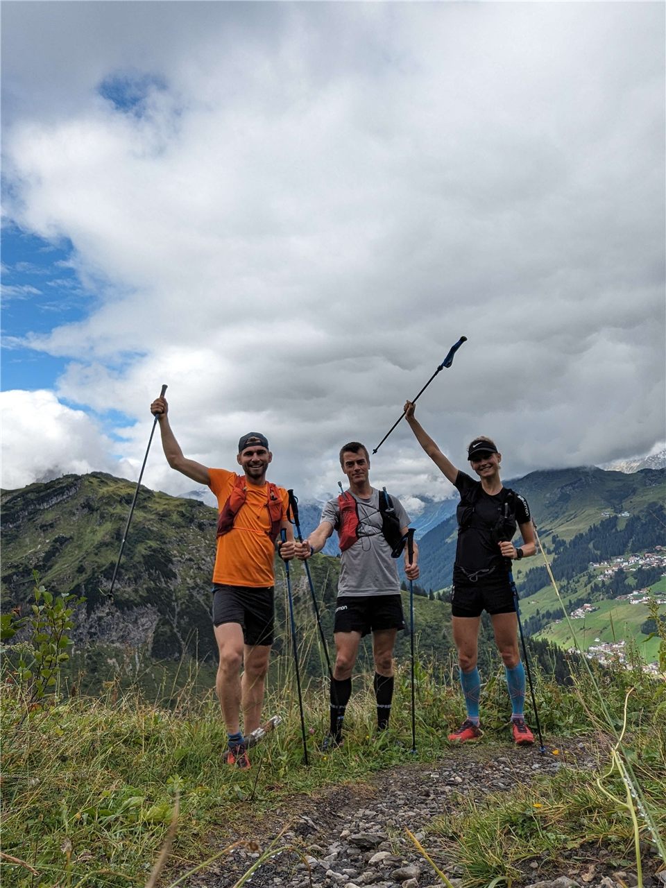 Three runners celebrating a shared mountain outing